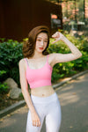 Une femme porte une brassière sport FIT.BELT rose qui évite les irritations